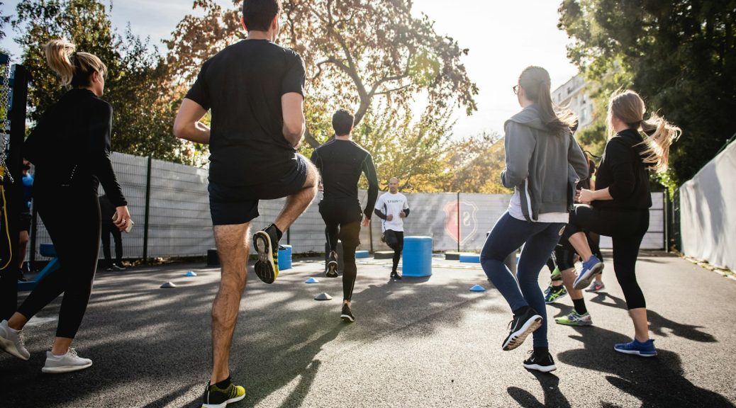 A group of people warming up on a street before a run