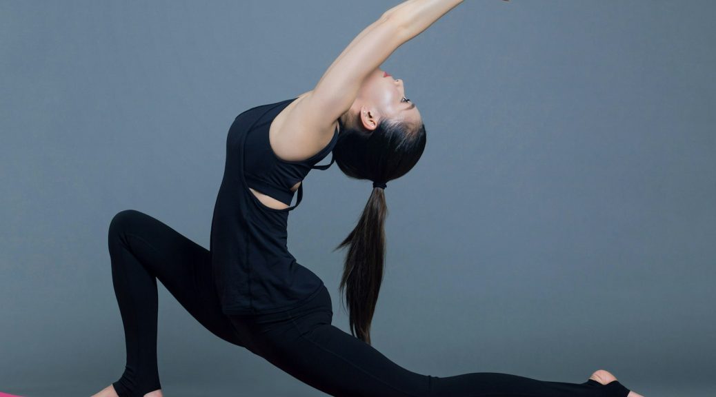 A woman doing a lunge stretch with one arm raised